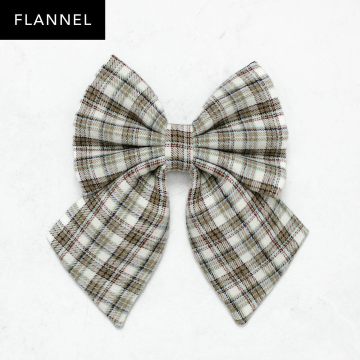 Plaid bow on a white background with 'Flannel' text above.